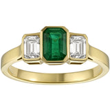 Emerald and diamond three stone ring with yellow gold band