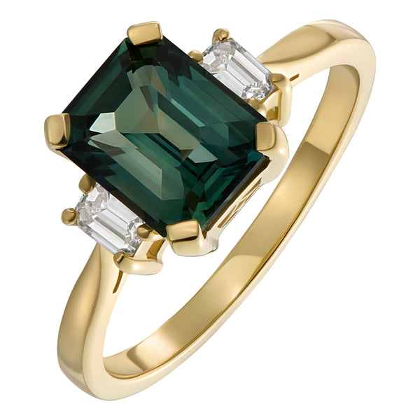 Teal sapphire emerald cut stone set in a yellow gold ring