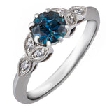 Teal sapphire ring with floral diamond leaves in platinum