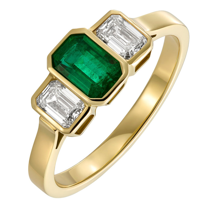 Three stone emerald and diamond engagement ring in 18ct yellow gold